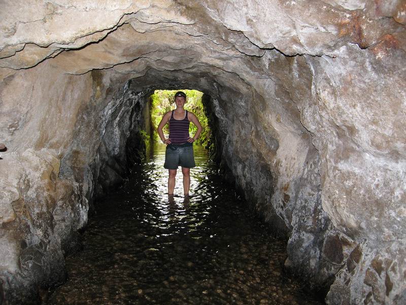 Amie standing in the irrigation tunnel entrance - note the 6-inch deep water!  
